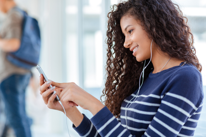 Woman staring at her phone while doing finances