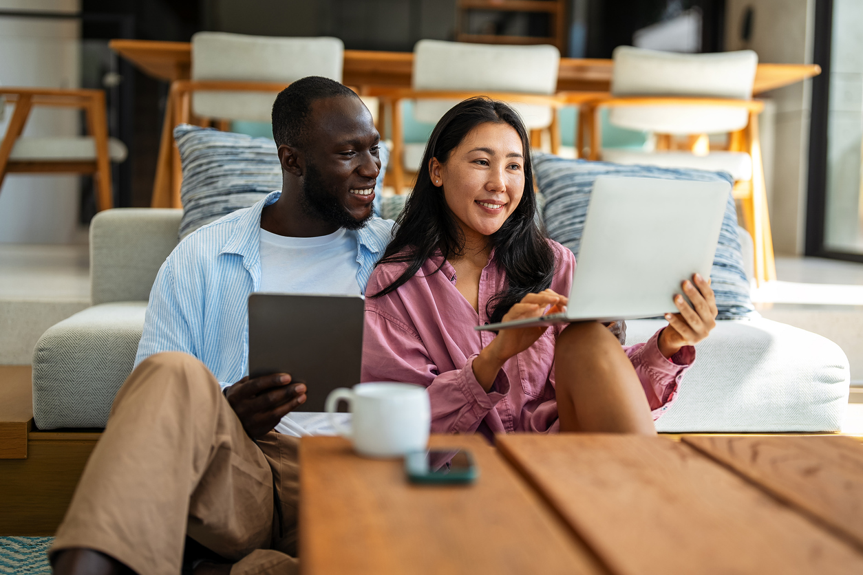 Couple working remotely, planning finances and investments online.